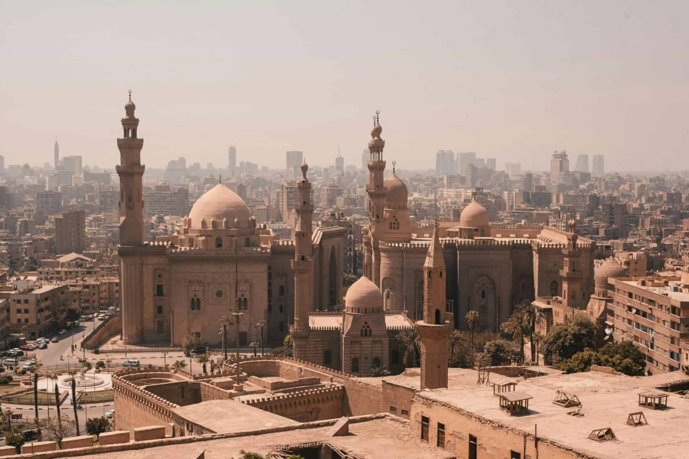 Egyptian mosque with minarets and domes in Cairo skyline.