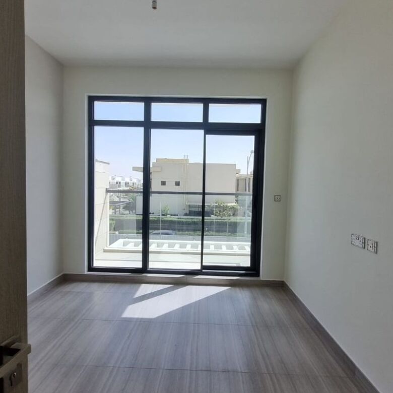 Scenic views from a modern Dubai apartment with large windows and balcony, ideal for comfortable liv.