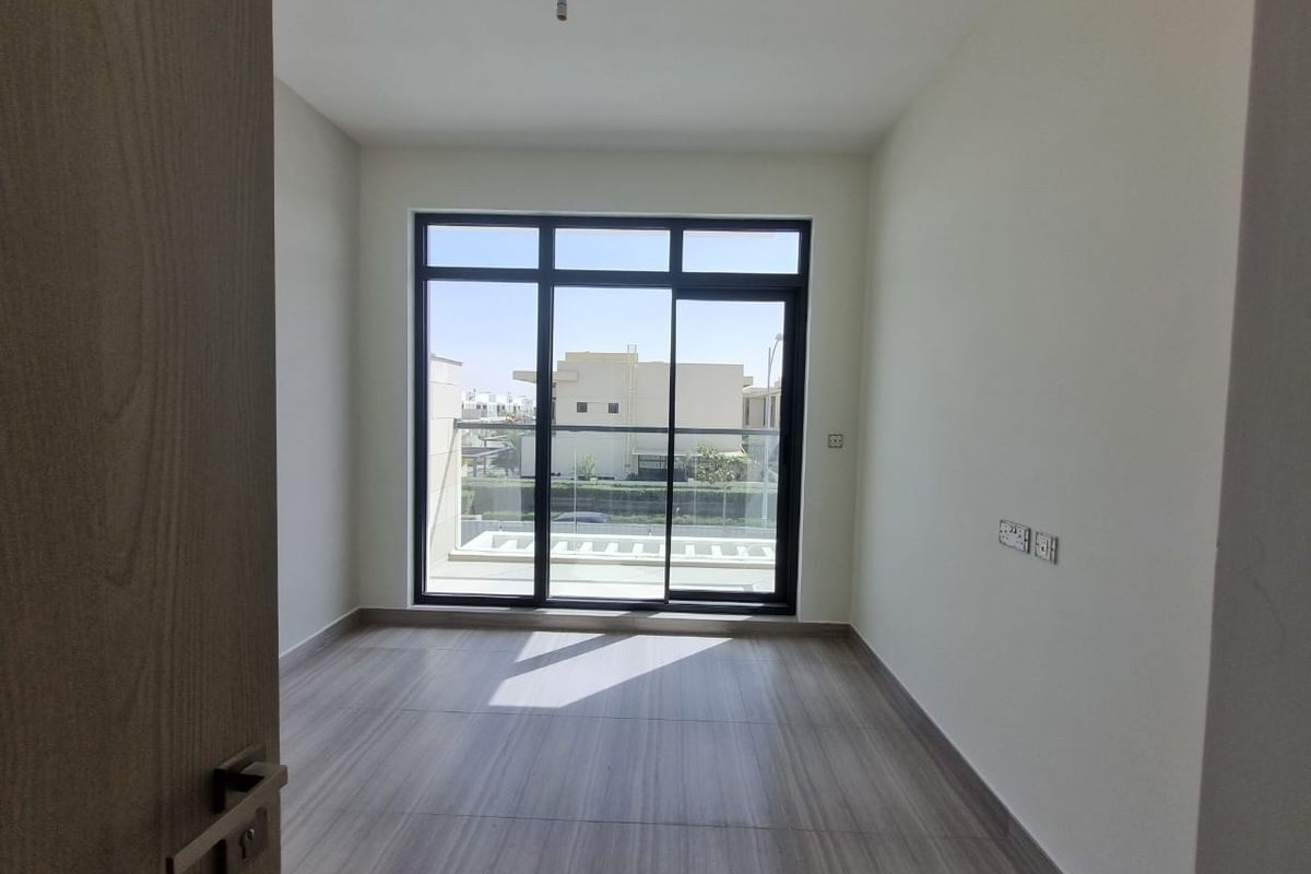 Scenic views from a modern Dubai apartment with large windows and balcony, ideal for comfortable liv.