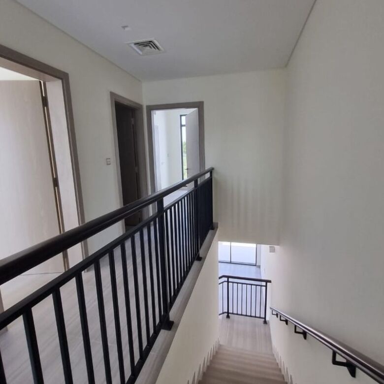 Scenic views from Dubai apartment staircase overlooking the city with balcony access and modern inte.