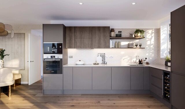 Bright and stylish grey kitchen with modern appliances in a luxury London apartment.