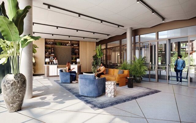 Modern lobby with seating area and large plants in a new residential building.