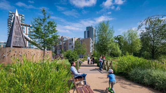 Scenic park with families and greenery in Wandsworth, London.