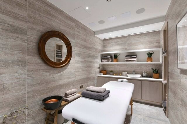 Luxurious spa treatment room in a high-end penthouse with modern decor.