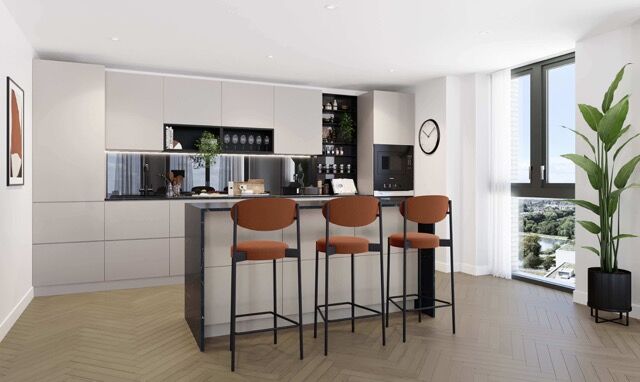 Modern 3-bedroom apartment kitchen with sleek cabinetry and a breakfast bar in Finsbury Park, London.