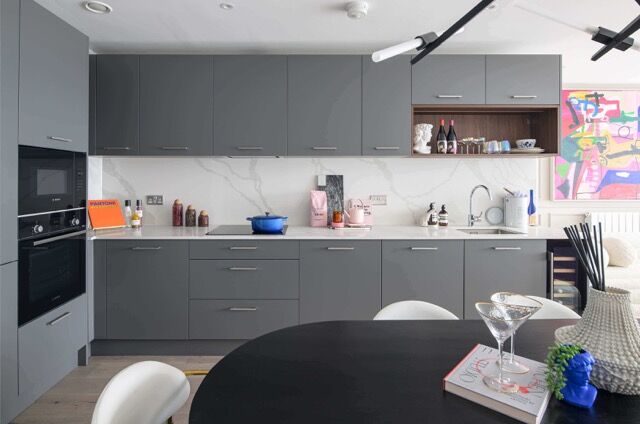 Modern grey kitchen in Woolwich, London, with sleek cabinetry and contemporary appliances.