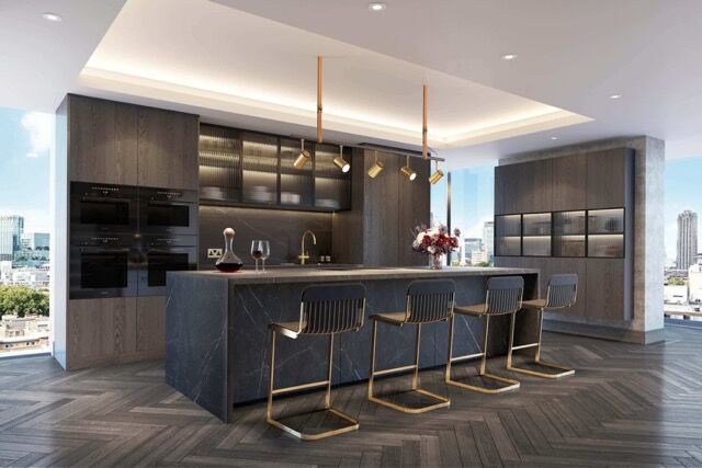 Modern penthouse kitchen featuring sleek dark cabinetry and a spacious island with seating.