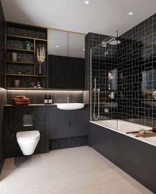 Stylish bathroom with black tiles, bathtub, and modern fixtures in a London apartment.