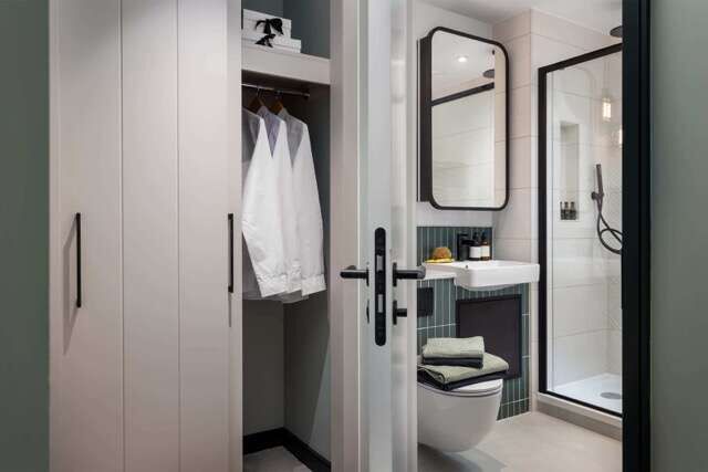 Elegant bathroom with closet and shower in Southall, London.