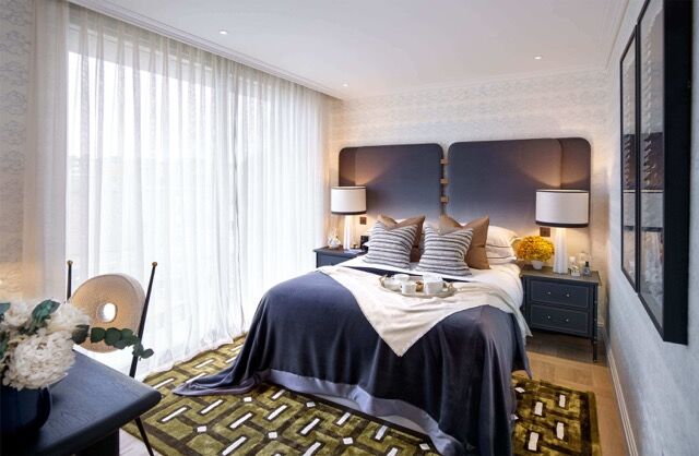 Luxury bedroom in Wandsworth, London, featuring modern decor, large windows, and elegant furnishings.