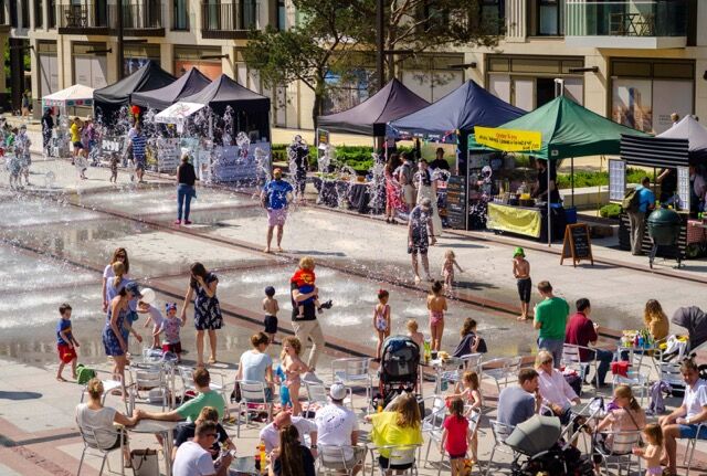 Family-friendly outdoor event with children playing and adults relaxing in Wapping.