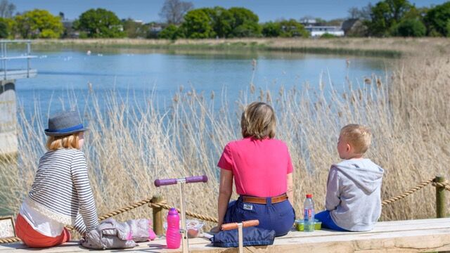 Beautiful view of a family enjoying a lakeside setting in Wandsworth, London.