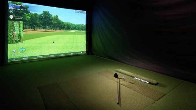 Modern apartment interior with golf simulator and city views in Wapping.