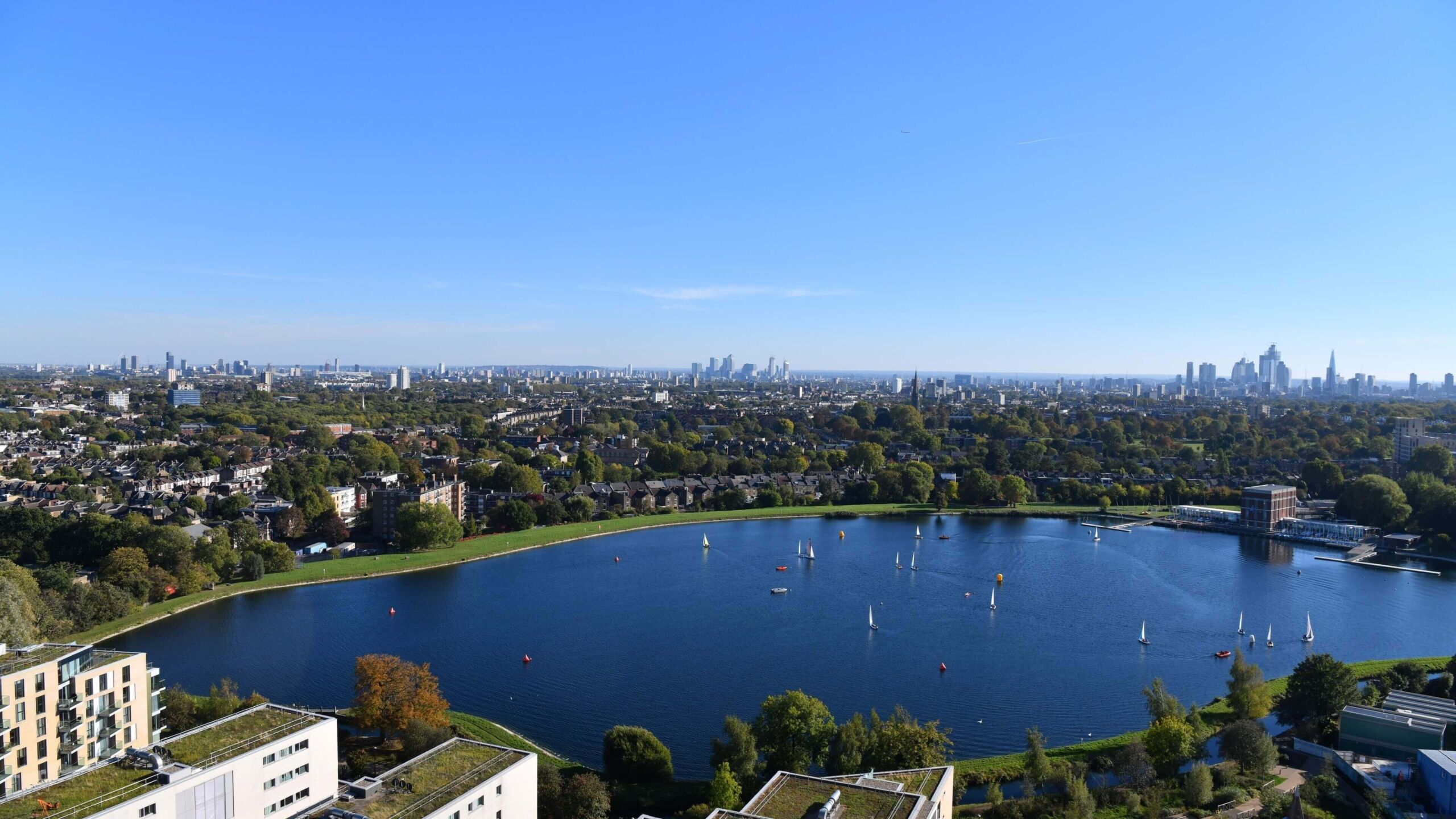 Beautiful view of Wandsworth's green spaces and lake with London skyline in the background.