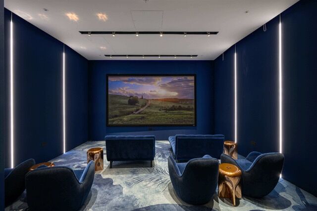 Modern 2-bedroom apartment interior with stylish seating and a large TV in Fulham, London.