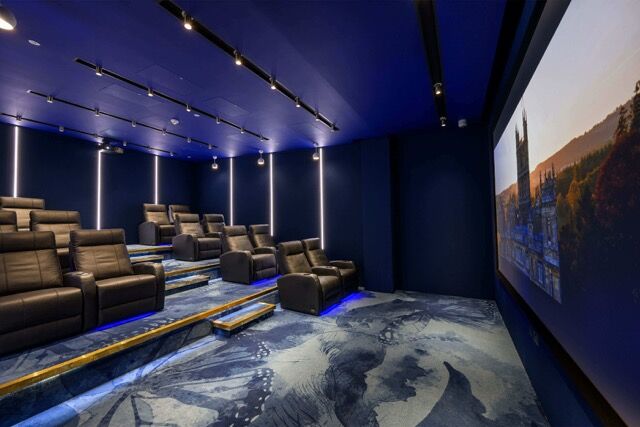Luxury home theater with plush seating and advanced audiovisual system in Fulham, London.