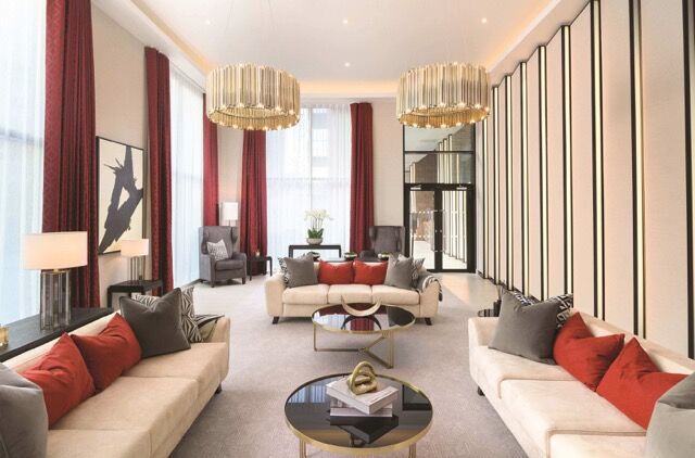 Elegant living room in modern Birmingham apartment with stylish furniture and lighting.