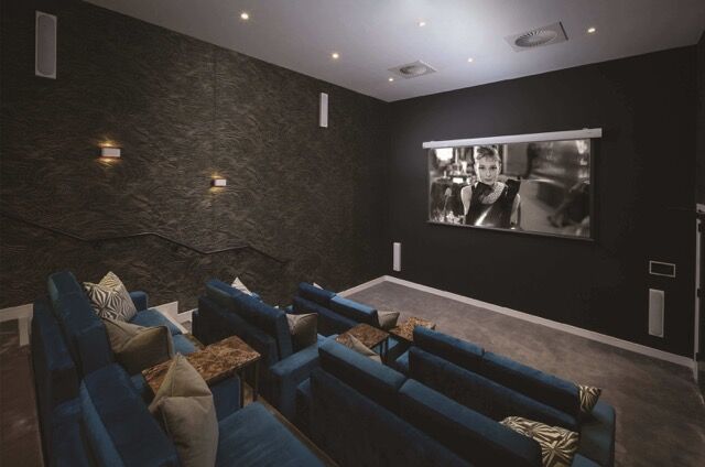 Home theater room with plush seating and large screen for movie nights near Birmingham.