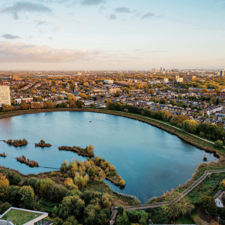 Beautiful aerial view of a serene lake surrounded by lush greenery in Wandsworth, London.