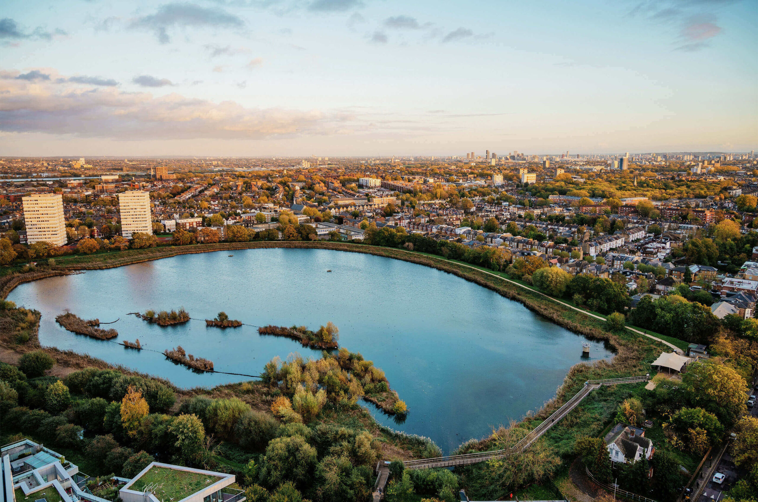 Beautiful aerial view of a serene lake surrounded by lush greenery in Wandsworth, London.