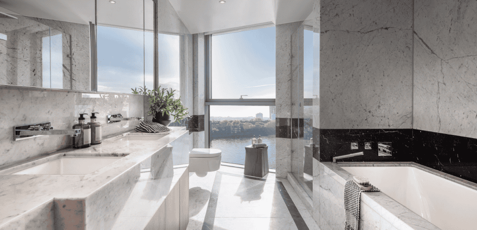 Modern Chelsea waterfront bathroom with panoramic city views and elegant marble finishes.