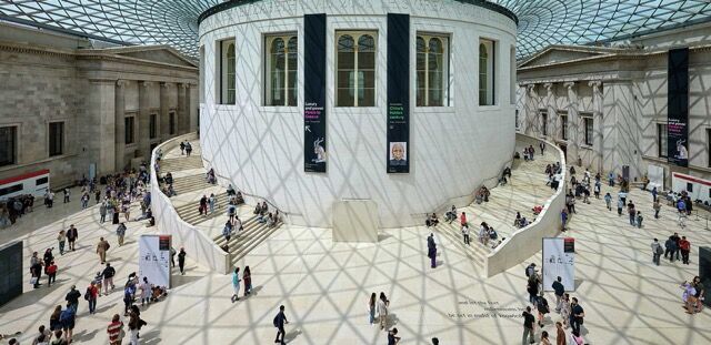 Interior view of a modern museum with visitors exploring exhibits and architecture.