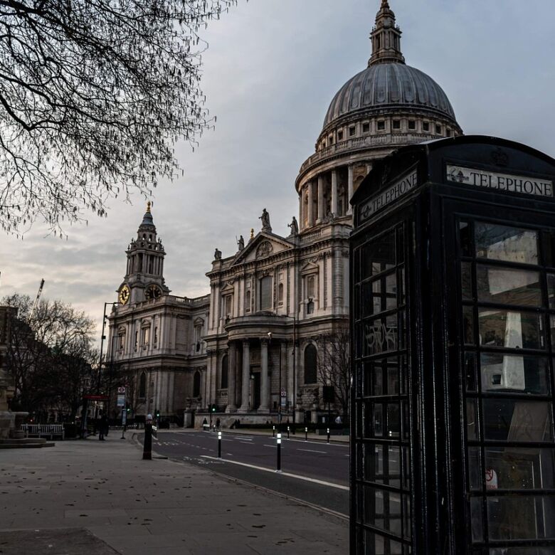 Historic St. Paul's Cathedral and iconic telephone booth in London.