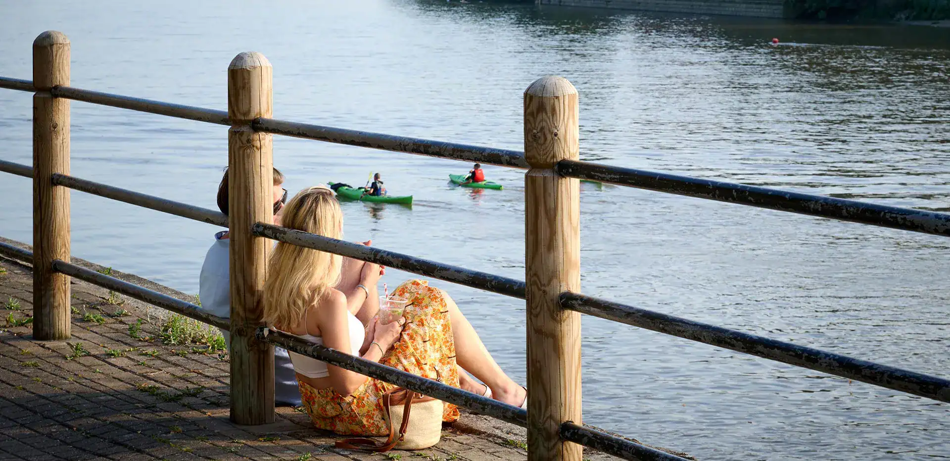 Woman relaxing by the river in Fulham, enjoying scenic views and peaceful surroundings.