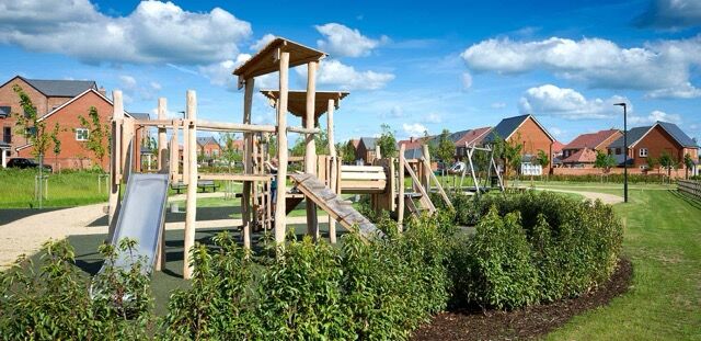 Modern playground in Wallingford neighborhood with lush greenery and family-friendly amenities.