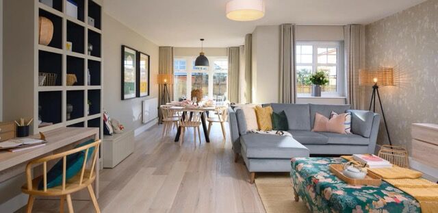 Bright and spacious living room with contemporary furniture and large windows.