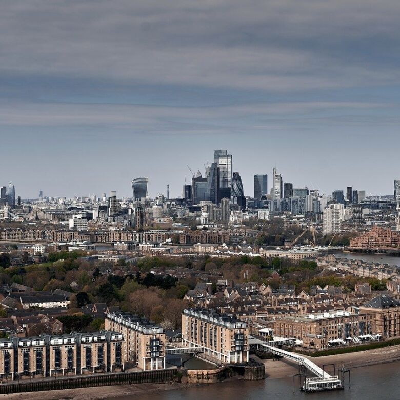 Panoramic view of London skyline from Woolwich, showcasing iconic skyscrapers and the River Thames.