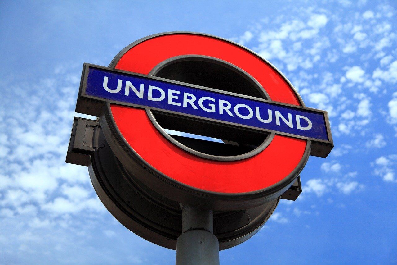 London Underground station sign with blue sky background.