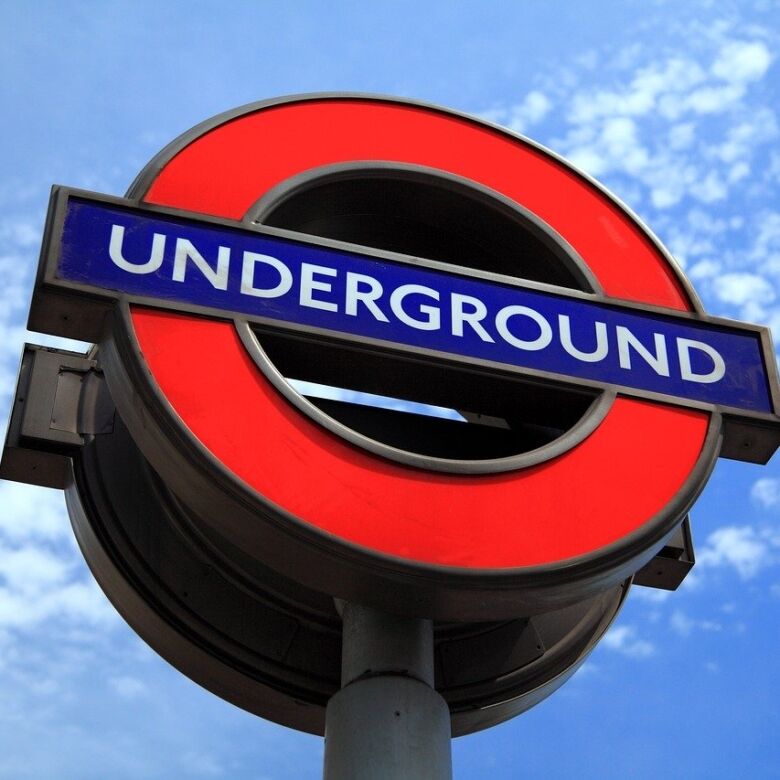 London Underground station sign with red circle and blue bar.