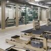 Gym interior with fitness equipment and workout areas at Hendon Homes. Convenient access to central.