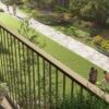 Balcony overlooking lush garden with walking path in Hendon, London.