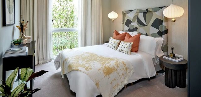 Modern bedroom with scenic greenery view from window.