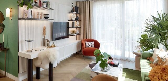 Modern living room in Hendon with stylish decor, large windows, and scenic surroundings.