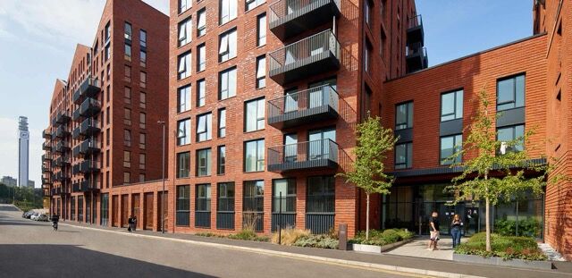 Contemporary apartments in Birmingham featuring private balconies and lush green surroundings.