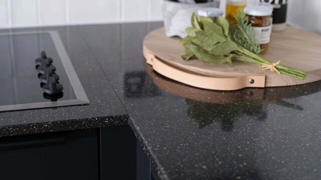 Modern kitchen with black countertop and cooking stove in a stylish apartment.