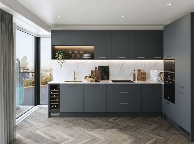 Modern blue kitchen with sleek cabinetry and marble backsplash in Woolwich, London.