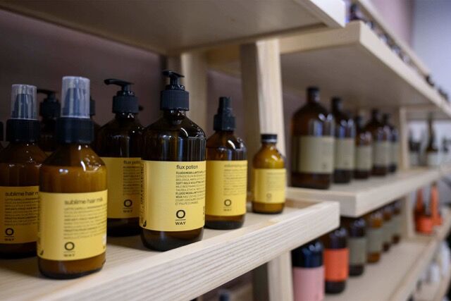 Modern wellness products on wooden shelves in Woolwich apartment.