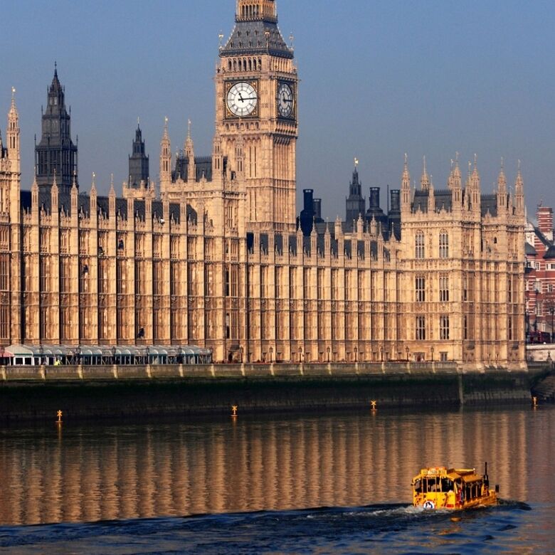 Big Ben and Houses of Parliament in London with river view.