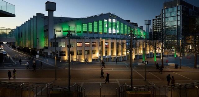 Investment Homes in Wembley Center of London, modern commercial building illuminated at night.