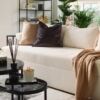 Bright, airy living room with comfortable sofa and lush indoor plants in a contemporary home.