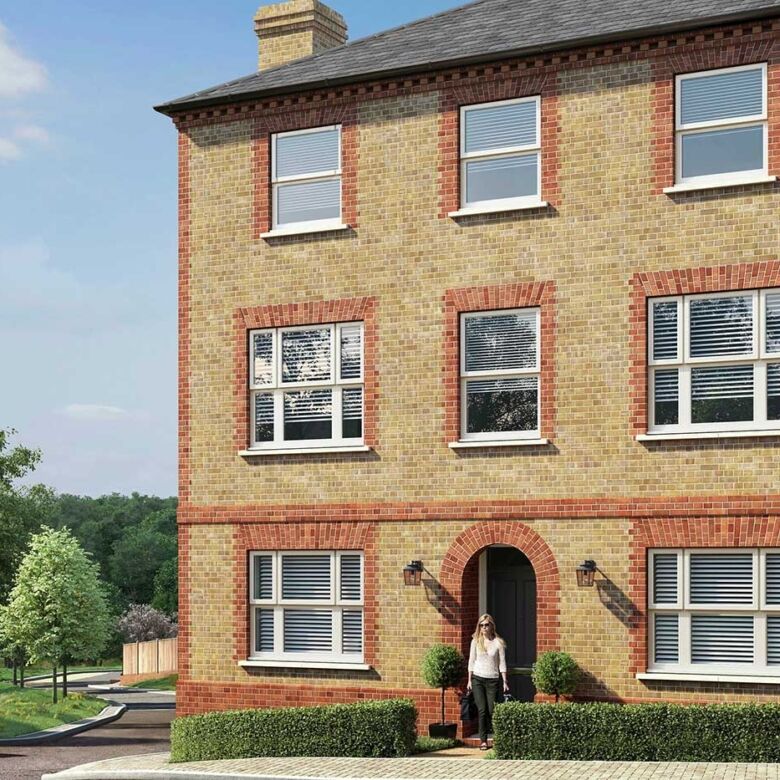 Modern brick house in Enfield with large windows and lush surroundings.