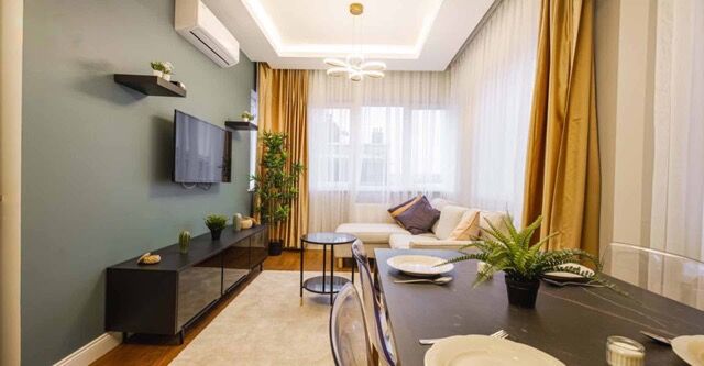 Bright living room with large windows, modern furniture, and stylish decor in Istanbul.