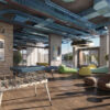 Loft with game table, bean bags, and large windows overlooking Sheffield skyline.