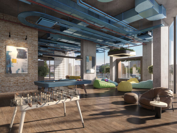 Loft with game table, bean bags, and large windows overlooking Sheffield skyline.
