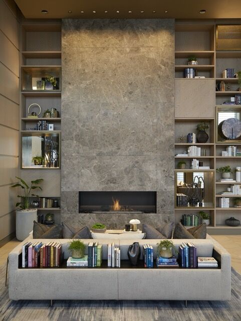 Elegant living room featuring a sleek fireplace, contemporary shelving, and stylish decor for upscal.