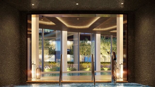Modern Riverside Apartment Entrance with glass doors and elegant lighting.